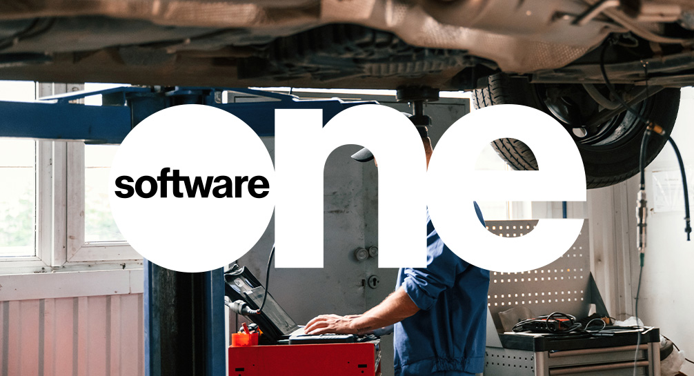 A man is working under a car with the word software on it.