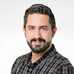 A man with a beard and a plaid shirt.