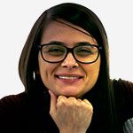 A woman wearing glasses is posing for a photo.