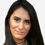 A woman with long dark hair is smiling.