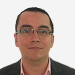 A man wearing glasses and a pink shirt.