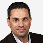 A man in a suit and tie is posing for a photo.