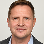 A portrait of a man in a suit and tie.