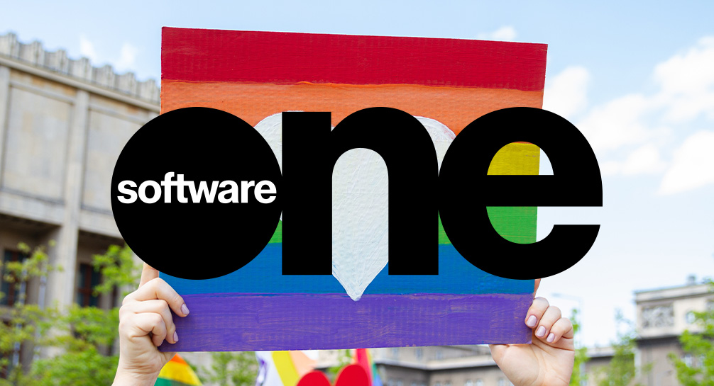 A person holding up a sign that says software one.